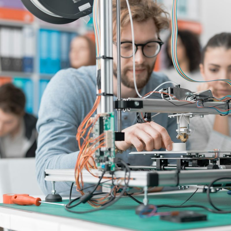 Students using a 3D printer